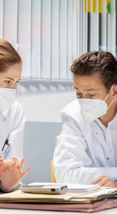 Ein Arzt bespricht sich mit einer Ärztin